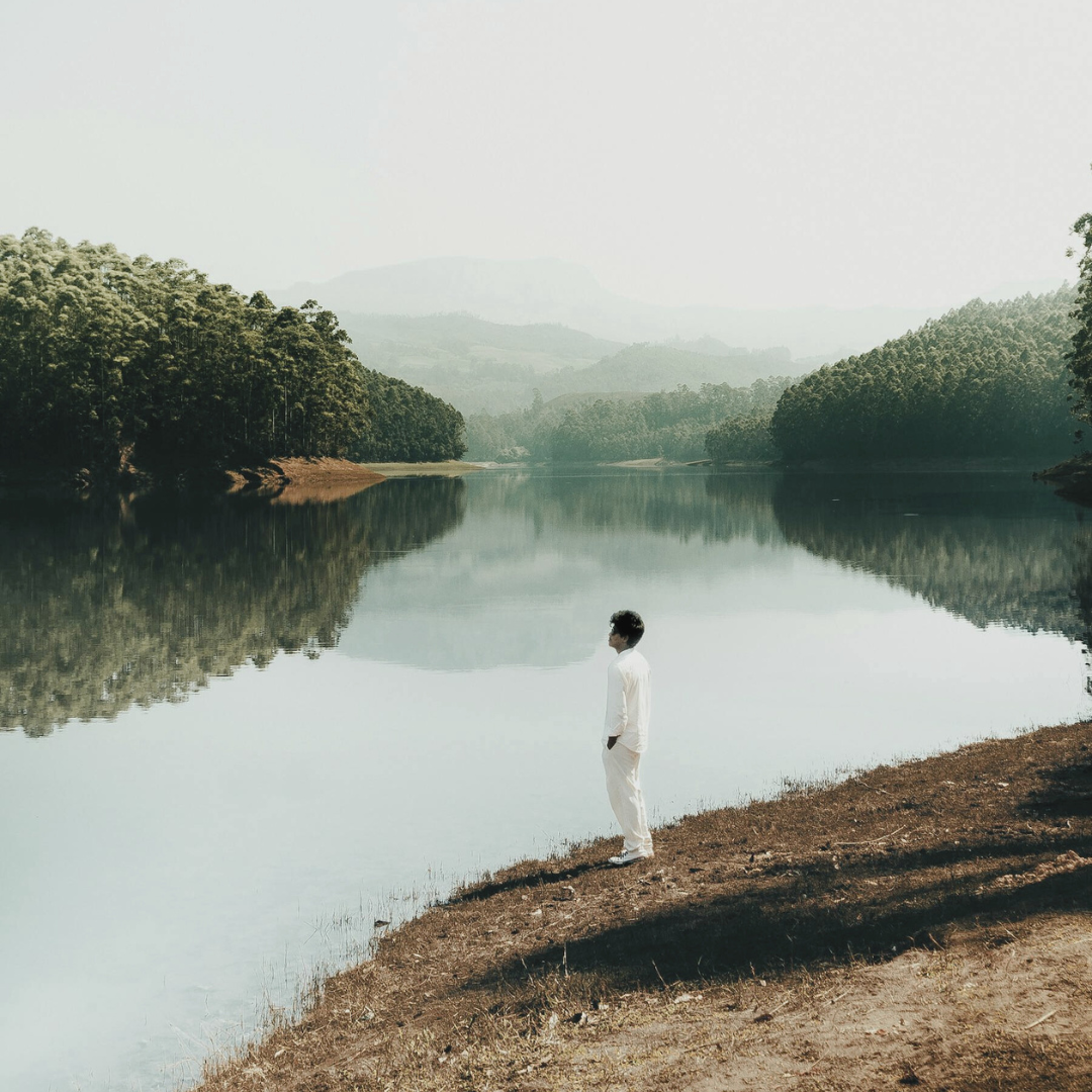 A person standing calmly in nature, breathing into the chest, representing owning anger with presence and self-respect